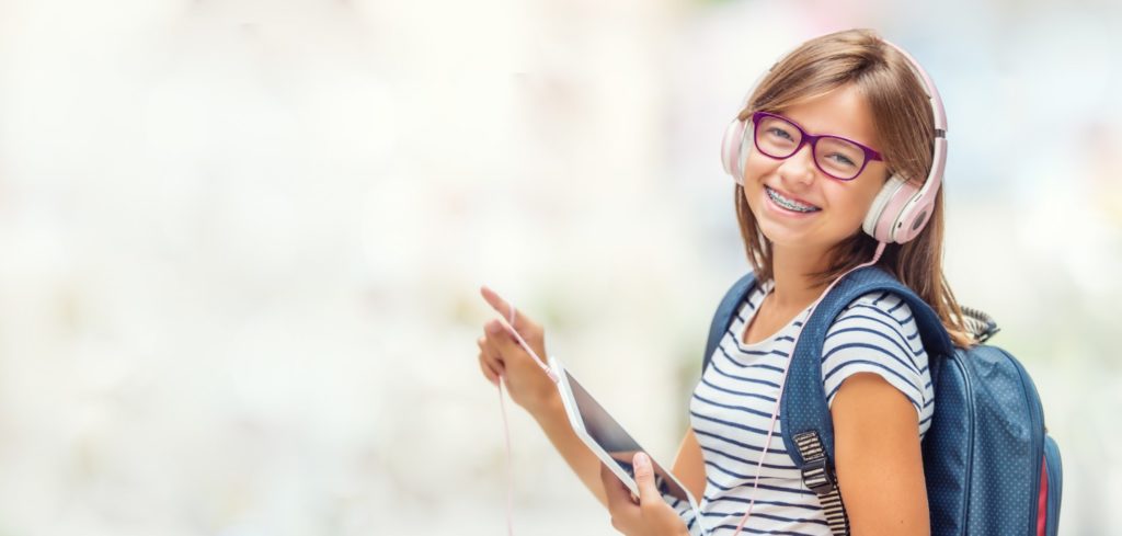 Girl smiling with glasses and headphone