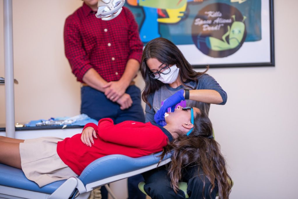 Dunn Orthodontics's assistant with a patient.